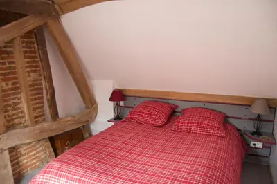 Un ou plusieurs lits dans un hébergement de l'établissement Au Fond du Jardin Maison d'hôtes