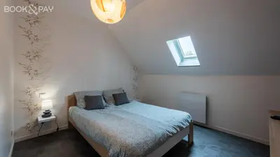 Un ou plusieurs lits dans un hébergement de l'établissement Appartement rénové tout confort