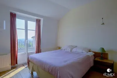 Un ou plusieurs lits dans un hébergement de l'établissement L' Eglise - 2 pièces avec balcon au dernier étage vue Paris