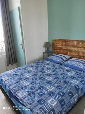 Un ou plusieurs lits dans un hébergement de l'établissement Studio Tribord Le Tréport - vue mer & falaises