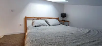 Un ou plusieurs lits dans un hébergement de l'établissement Maison Studio 4 personnes avec mezzanine