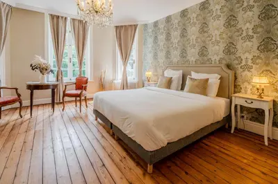 Un ou plusieurs lits dans un hébergement de l'établissement Le Manoir de la belle epoque