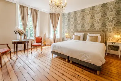Un ou plusieurs lits dans un hébergement de l'établissement Le Manoir de la belle epoque