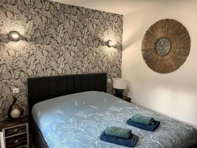 Un ou plusieurs lits dans un hébergement de l'établissement *Rivage* Spacieux T2 RDC sur cour:Jardin-Fibre-Netflix-Terrasse