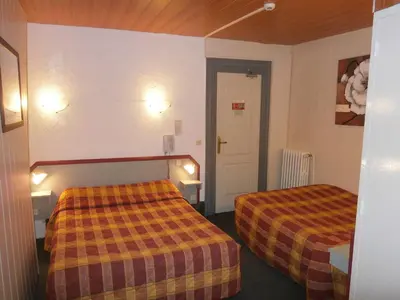 Un ou plusieurs lits dans un hébergement de l'établissement Hotel Beausejour