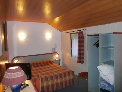 Un ou plusieurs lits dans un hébergement de l'établissement Hotel Beausejour