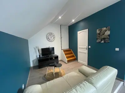 Télévision ou salle de divertissement dans l'établissement Appartement Amiens-Camon