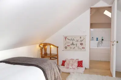 Un ou plusieurs lits dans un hébergement de l'établissement La Maison des Rues Pavées avec jardin by La Boîte En Plus