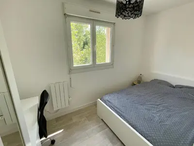 Un ou plusieurs lits dans un hébergement de l'établissement Appartement avec Loggia et Parking privé