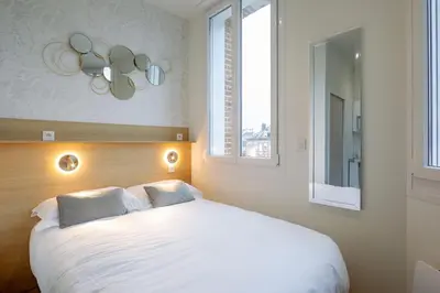 Un ou plusieurs lits dans un hébergement de l'établissement Appartement 2 proche de la gare et centre ville