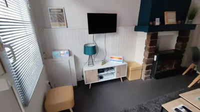 Télévision ou salle de divertissement dans l'établissement L'Auxy