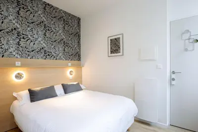 Un ou plusieurs lits dans un hébergement de l'établissement Appartement 3 proche de la gare et du centre ville