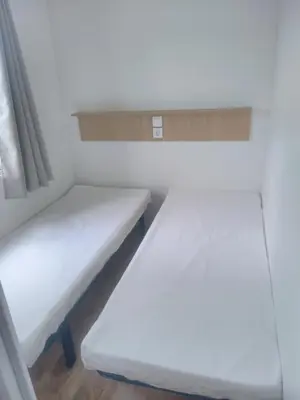 Un ou plusieurs lits dans un hébergement de l'établissement Camping Les Voiles