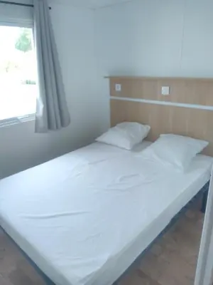 Un ou plusieurs lits dans un hébergement de l'établissement Camping Les Voiles