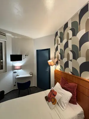 Un ou plusieurs lits dans un hébergement de l'établissement Hôtel Astrid