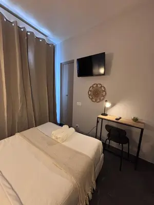 Un ou plusieurs lits dans un hébergement de l'établissement Hôtel Astrid