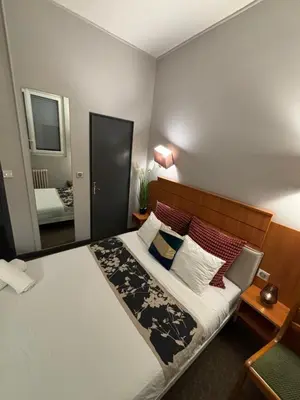 Un ou plusieurs lits dans un hébergement de l'établissement Hôtel Astrid