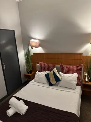 Un ou plusieurs lits dans un hébergement de l'établissement Hôtel Astrid