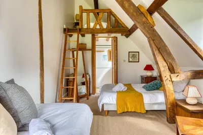 Un ou plusieurs lits dans un hébergement de l'établissement Gîte le Clos Saint Lucien - Fêtes Mariages Week end en Normandie