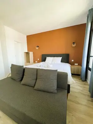 Un ou plusieurs lits dans un hébergement de l'établissement villa Konny studio 1er étage