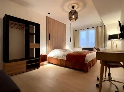 Un ou plusieurs lits dans un hébergement de l'établissement Le Tulum Spa - Jacuzzi & Sauna