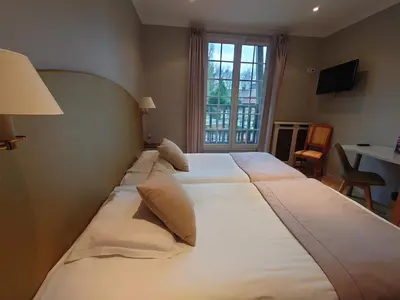 Un ou plusieurs lits dans un hébergement de l'établissement Hotel Le Continental