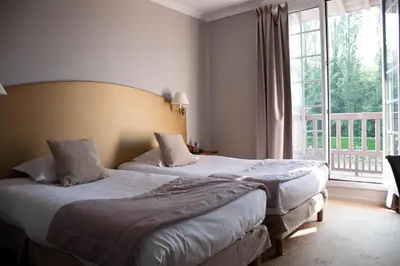Un ou plusieurs lits dans un hébergement de l'établissement Hotel Le Continental