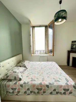 Un ou plusieurs lits dans un hébergement de l'établissement Appartement chaleureux 1
