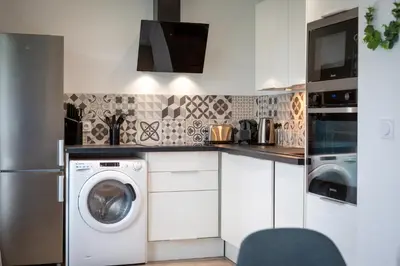 Cuisine ou kitchenette dans l'établissement Appartement tout confort - Parking privé gratuit
