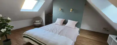 Un ou plusieurs lits dans un hébergement de l'établissement Les Hortensias Roses Duplex