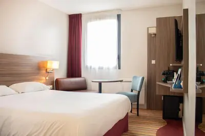 Un ou plusieurs lits dans un hébergement de l'établissement Brit Hotel Dieppe