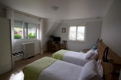 Un ou plusieurs lits dans un hébergement de l'établissement Au Jardin Saint Laurent