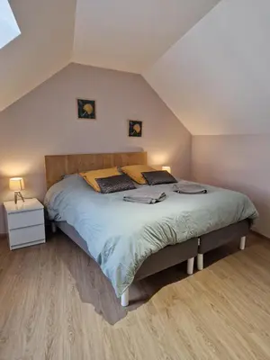 Un ou plusieurs lits dans un hébergement de l'établissement Maison de charme avec jardin au bord de l'Eure