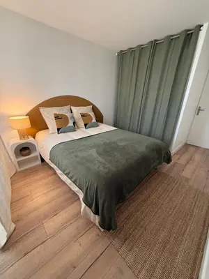 Un ou plusieurs lits dans un hébergement de l'établissement Appartement Cosy Cergy Le Haut Gare