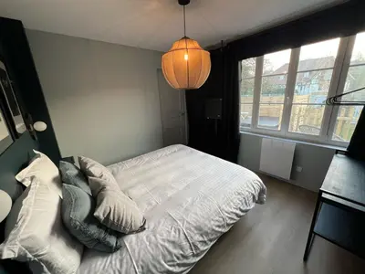 Un ou plusieurs lits dans un hébergement de l'établissement Appartement avec Jacuzzi - Accès Piscine partagée