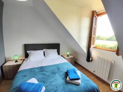 Un ou plusieurs lits dans un hébergement de l'établissement Le gite du village
