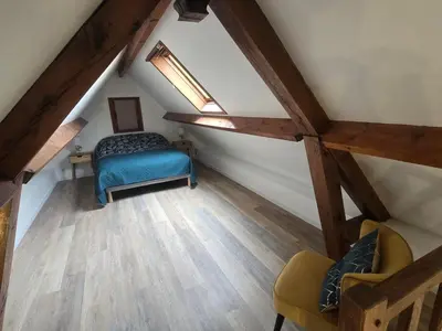 Un ou plusieurs lits dans un hébergement de l'établissement Charmante Maison au calme