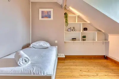 Un ou plusieurs lits dans un hébergement de l'établissement Les agapanthes jolie maison de ville à Rouen avec extérieur terrasse