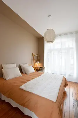Un ou plusieurs lits dans un hébergement de l'établissement Les Chambres du 32