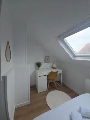 Un ou plusieurs lits dans un hébergement de l'établissement Maison cosy et calme à proximité de la gare
