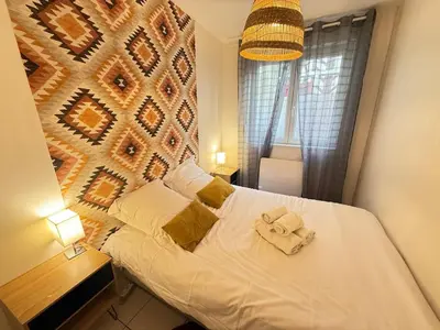 Un ou plusieurs lits dans un hébergement de l'établissement T2 Ambiance Savane - hyper centre