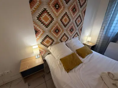 Un ou plusieurs lits dans un hébergement de l'établissement T2 Ambiance Savane - hyper centre