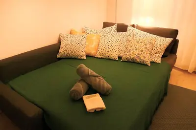 Un ou plusieurs lits dans un hébergement de l'établissement Studio jardin de l'hôtel de ville