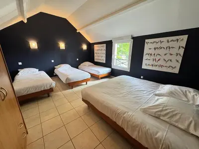 Un ou plusieurs lits dans un hébergement de l'établissement Gîte 6 chambres du Moulin de Fourges privatisable - 19 personnes