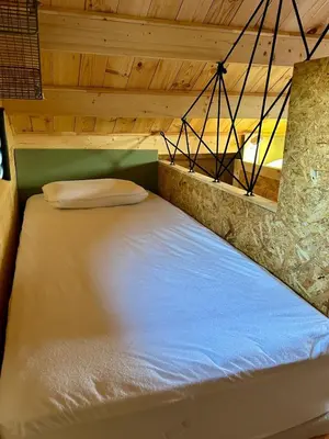 Un ou plusieurs lits dans un hébergement de l'établissement Cosy Lodgy