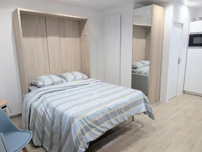 Un ou plusieurs lits dans un hébergement de l'établissement Studio calme et équipé proche Paris