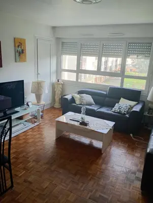 Coin salon dans l'établissement Location appartement