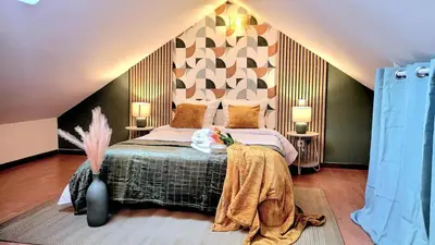 Un ou plusieurs lits dans un hébergement de l'établissement Le Duplex du Moulin - Maison T2 cosy centre-ville