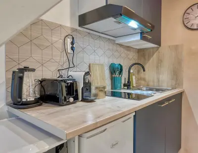 Cuisine ou kitchenette dans l'établissement Le Duplex Cosy