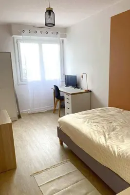 Un ou plusieurs lits dans un hébergement de l'établissement Coloc studio standing mueble netflix gare